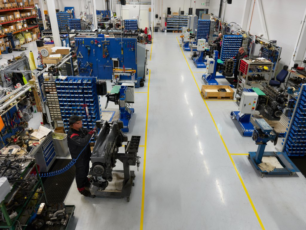 Three engine assemblers assembling engines at AGCO Power’s new, expanded remanufacturing production facilities in Linnavuori. Reman means factory remanufacturing of an engine.
